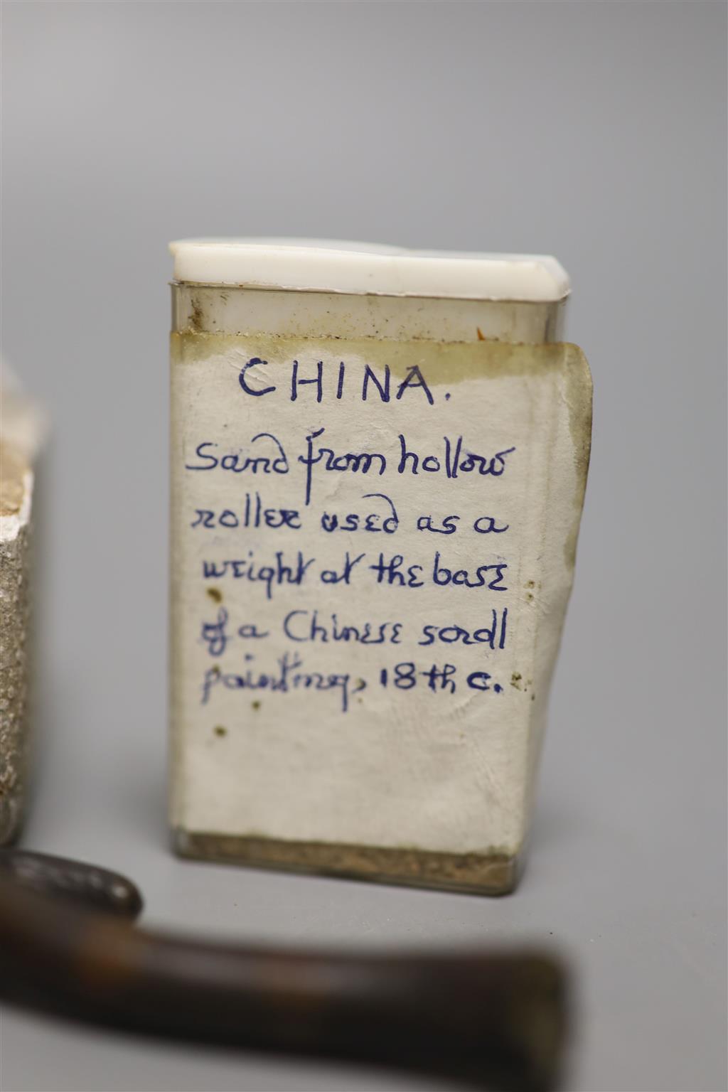 A group of Chinese and Japanese objects, 19th/20th century, including an inscribed ink box an inkstone, a lacquer bookslide, two Tibeta